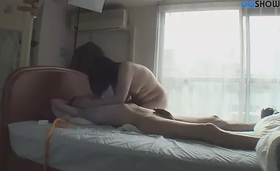 A submissive man receives a handjob and nipple pinches from an eager Asian goddess